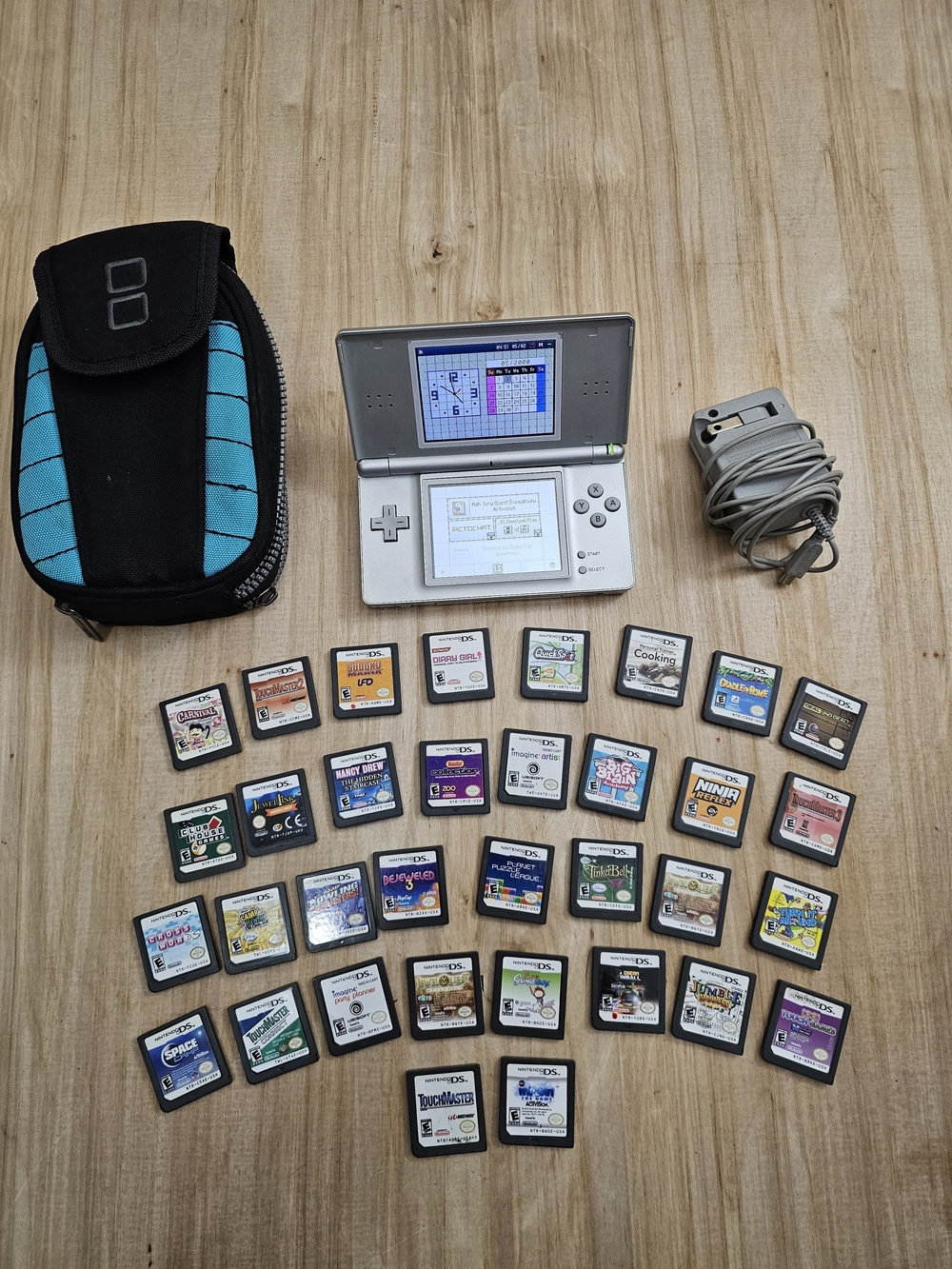 Nintendo DS Lite Package Silver Handheld with Black/Teal Case, Charger 35 Games